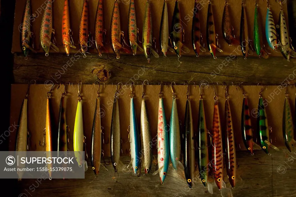 Colorful Fishing Lures hanging on wall, Lapland, Finland - SuperStock