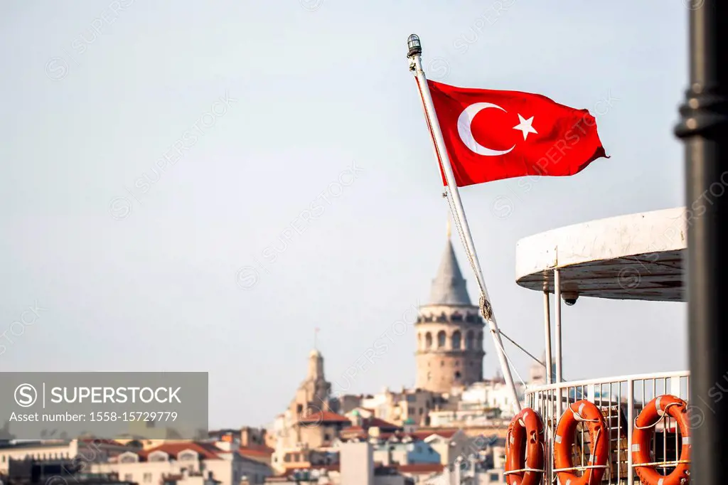 Turkish flag in front of the Galata tower in Istanbul, Turkey.