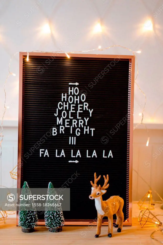 Letterboard Christmas Hohoho and Falalalala with Christmas decorations and fairy lights