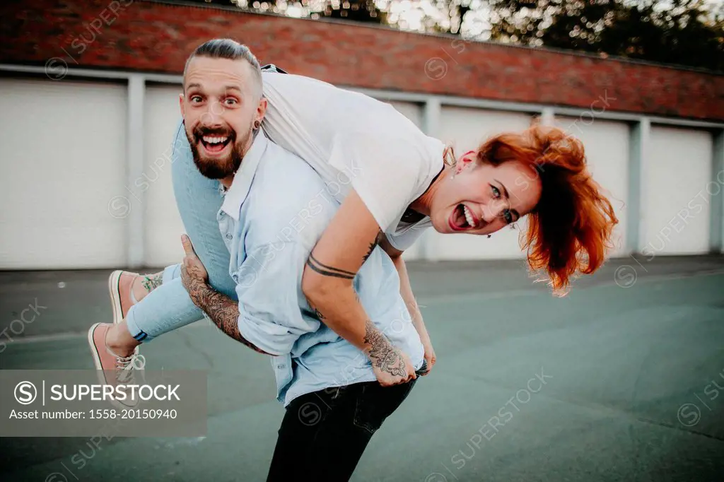 Young couple in love, fun, fooling around, outside