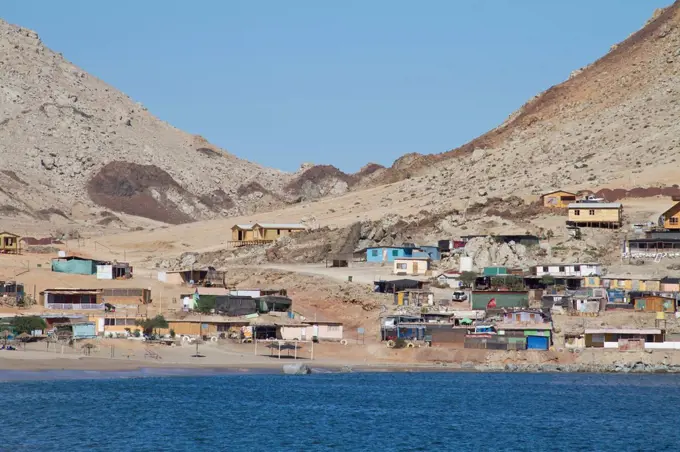 coloured houses of a fishing village at the Atlantic coast, Northern Chile