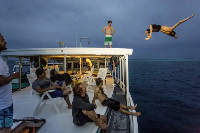 Boy is jumping from boat