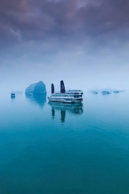 Vietnam, Halong Bay, tourist boats, dawn