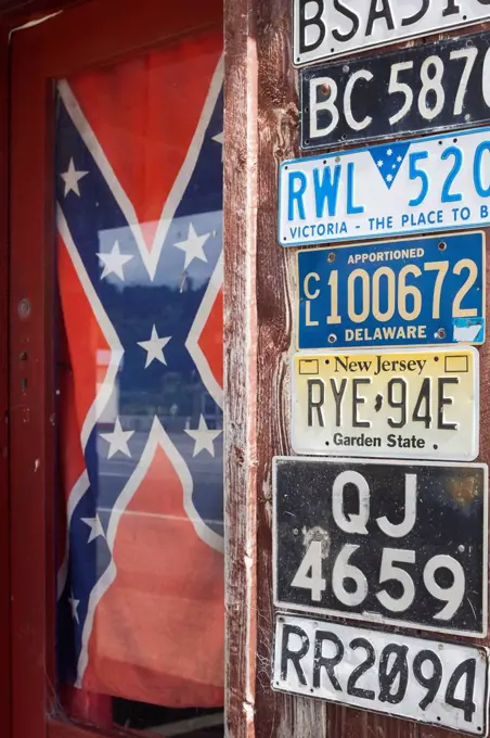 New Zealand, South Island, West Coast, Ross, USA license plates and US Confederate Rebel flag