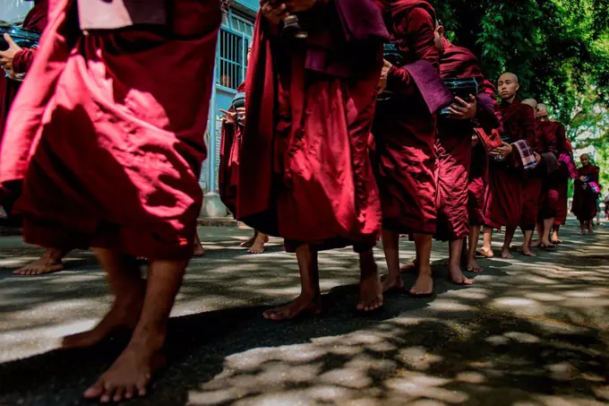 Mahagandayon Monastery, Amarapura, Myanmar, South East Asia. Monks in a row for the ritual of lunch.