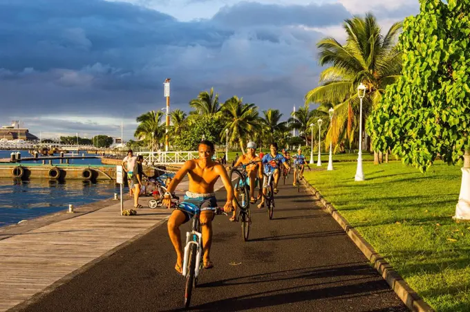 Local boys on their bicycles, Waterfront of Papeete, Tahiti, French Polynesia