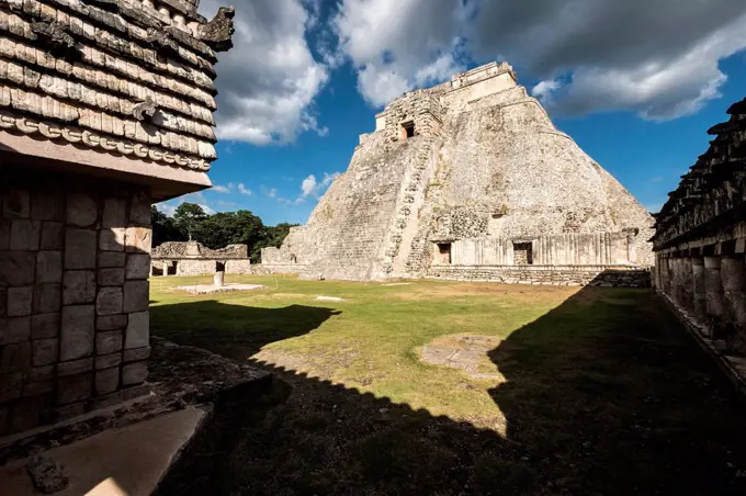 Uxmal, Yucatan, Mexico - October 13, 2017: The Pyramid of the Magician (Pirámide del Mago) towering in the Maya City of Uxmal, Mexico