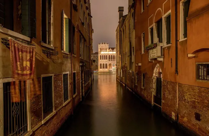 Old row of houses at canal at night, Venice, Veneto, Italy