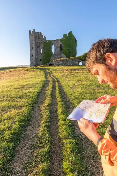 Hiker with map, Ballycarbery Castle, Cahersiveen, County Kerry, Ireland