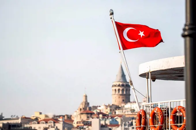 Turkish flag in front of the Galata tower in Istanbul, Turkey.