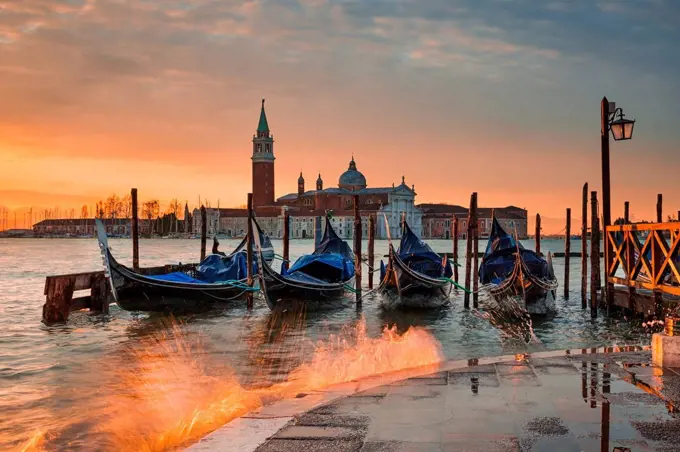 Gondolas on the Grand Canal at sunrise in Venice, Italy