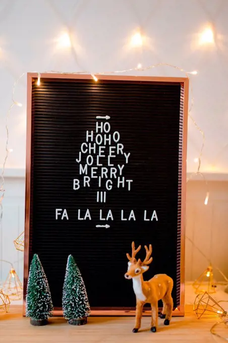 Letterboard Christmas Hohoho and Falalalala with Christmas decorations and fairy lights