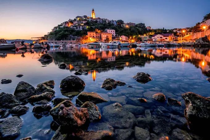 Morning view of a Mediterranean place by the sea, beautiful illuminated skyline of the town of Vrbnik and its bay. Island krk, Croatia