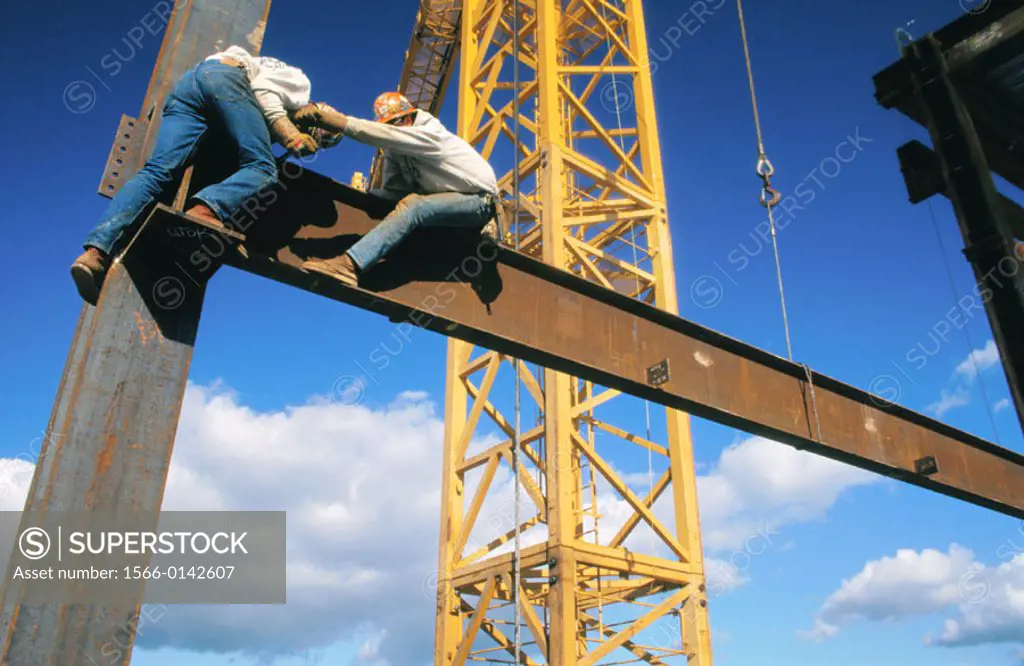 Ironworkers connecting steel beams