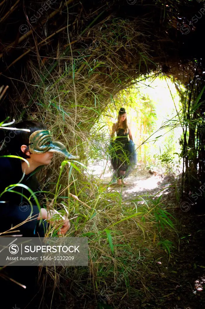 goblin waiting for lady to walk thru the tunnel of bushes