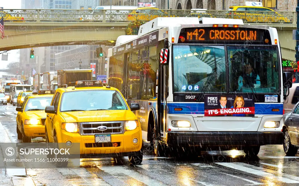 Mass Transit on Pershing Square, M42 MTA Crosstown Bus, outside Grand Central Terminal, morning rush hour during a snow and rain storm, Madison Avenue...