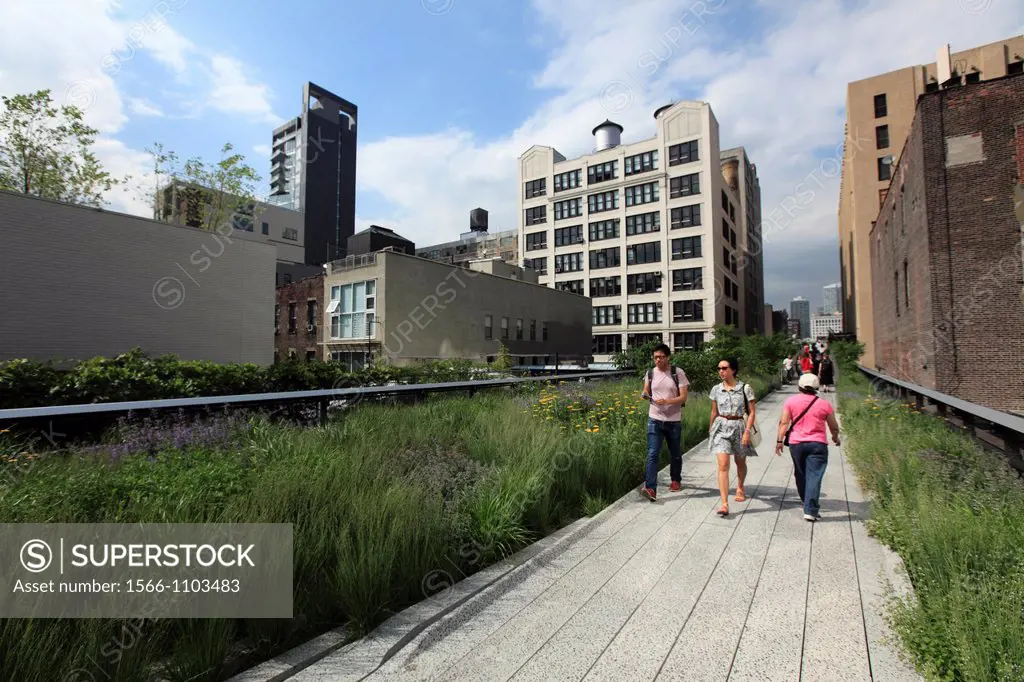 Visitors walking on the High Line Park a linear park built on a section of former elevated New York Central Railroad which runs along the lower west s...