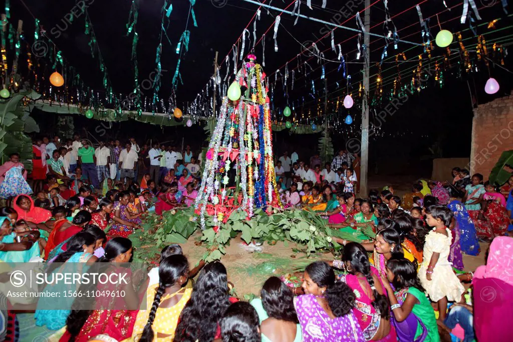 Tribal women performing Puja during Karma festival night. Jerkatand village, Bokaro District Jharkhand, India.