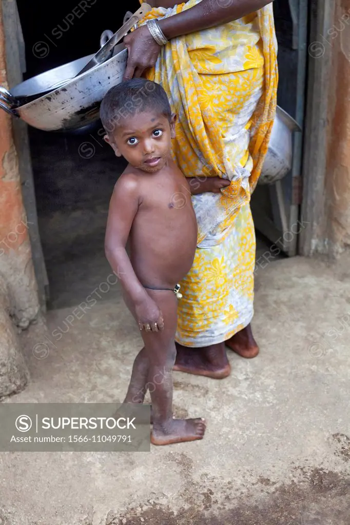 Portrait of a tribal boy without clothes in village. Munda tribe. Bartoli village Khunti District Ranchi, Jharkhand, India.