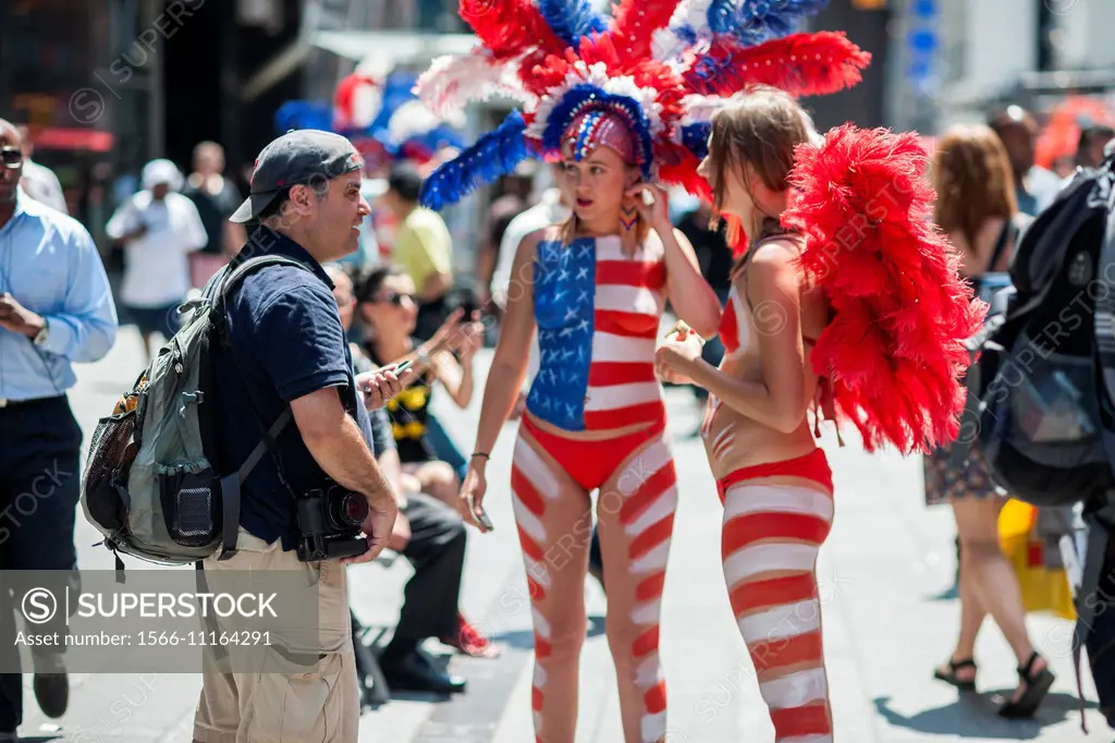 NEW YORK-MAY 20: A Pretty Lady In Patriotic Red, White And Blue Body Paint  Looks For Tips From Tourists With Cameras In Times Square On May 20 2014 In  Manhattan. Stock Photo