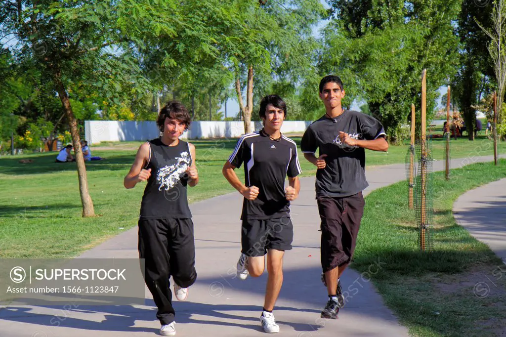 Argentina, Mendoza, Parque General San Martin, public park, pathway, trees, landscaping, Hispanic, boy, teen, fitness, sports, jogging, running, physi...