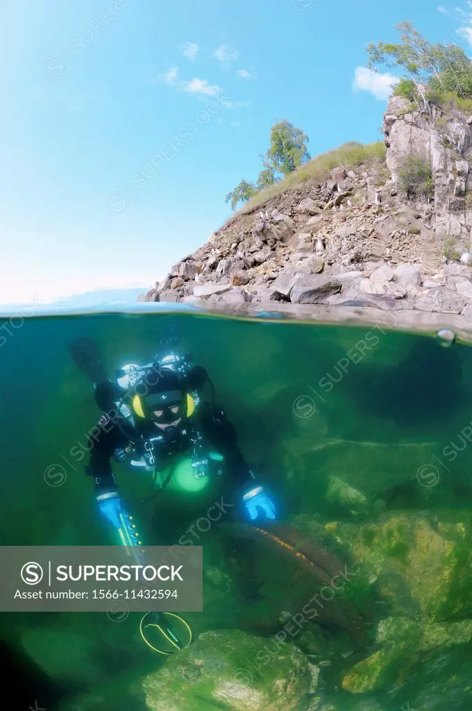 Diver with the metal detector searching for underwater treasure, lake Baikal, Siberia, Russia, Eurasia.