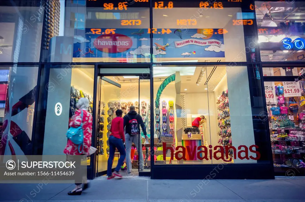 Tourists pass the newly opened Havaianas store in Times Square in