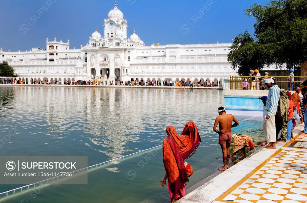 India. Punjab. Amritsar. The Golden Temple. The sacred pool Anrit Sarovar pool of Nectar of Immortality, the Parikrama Marble Path or ambulatory for S...