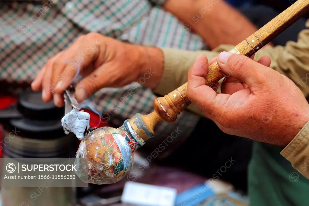 Nomad holding an opium pipe, smoking opium, Zagros mountains, Central Iran, Asia.