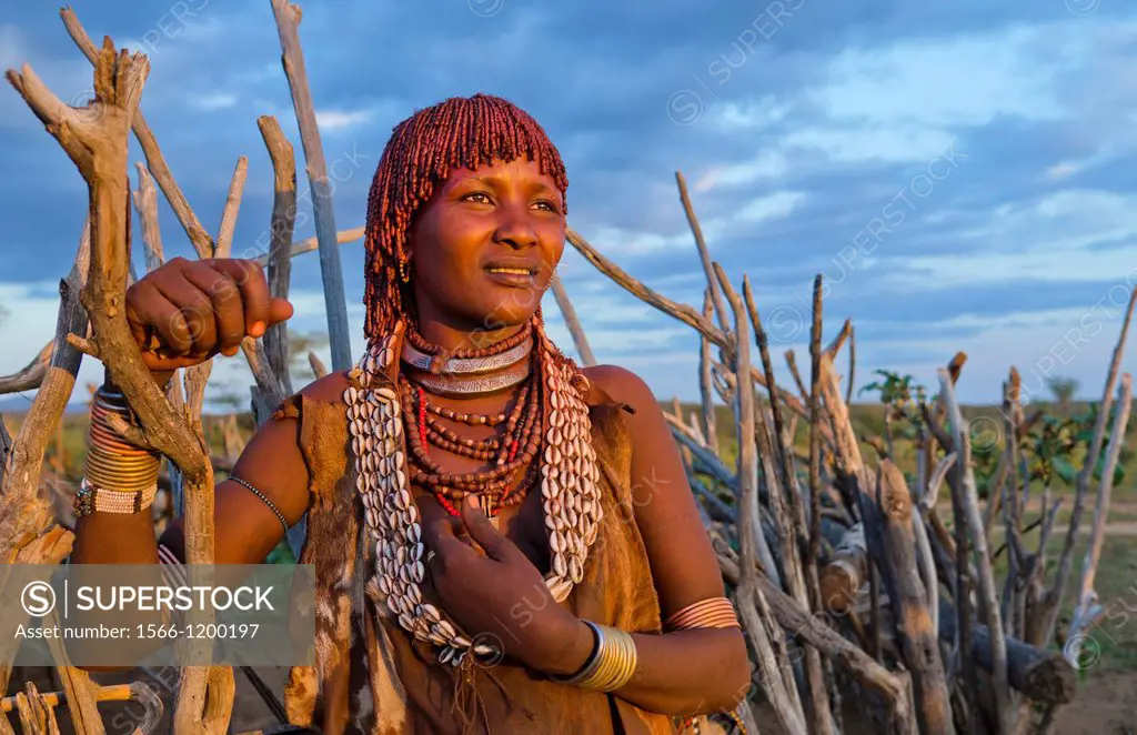 Turmi Ethiopia Africa Lower Omo Valley village with Bena Tribe First Wife smiling in sunset in wood hut village 24