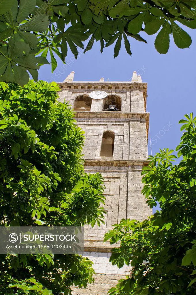 Nuestra Senora de la Misericordia church and trees at Duenas, tower, historical village of Palencia, Castilla y Leon, Spain