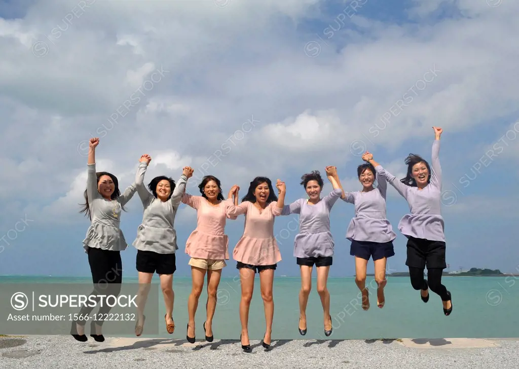 Naha, Okinawa, Japan: Japanese women jumping for happiness during their 30th birthday at Senaga-jima