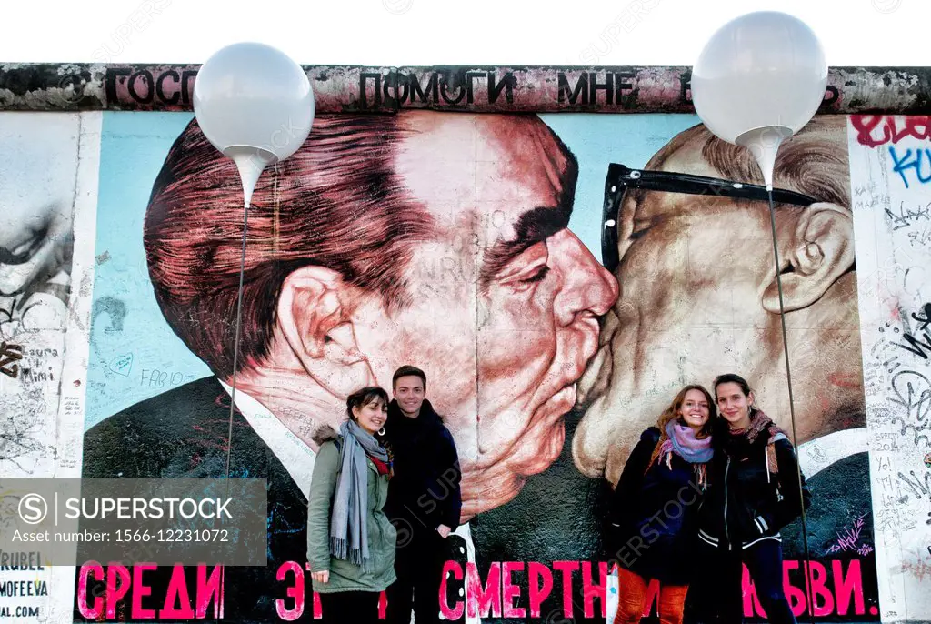 East Side Gallery, Berlin wall, young people in front of one of the most famous mural ever saying ´My God, help me to survive this deadly love´ by Dmi...