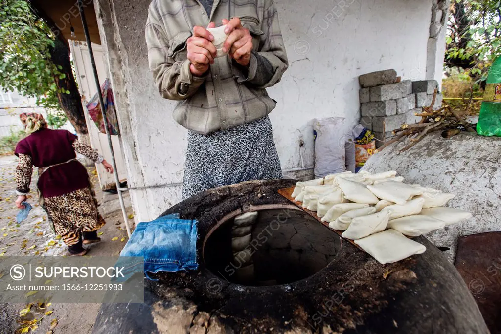 Traditional family bakery and small restaurant with tandoor, clay oven,  where samsa, traditional Uzbek pastry with ground lamb and onion, are baked  an - SuperStock