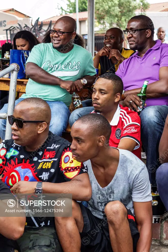 South Africa, African, Johannesburg, Soweto, Vilakazi Street Precinct, Sakhumzi, restaurant, Black, man, friends, watching, soccer match, football, Or...