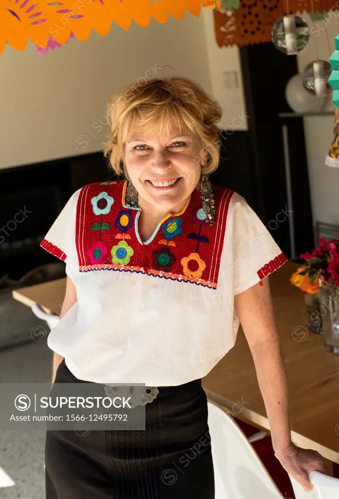 woman, 64, in Mexican clothing at a party.