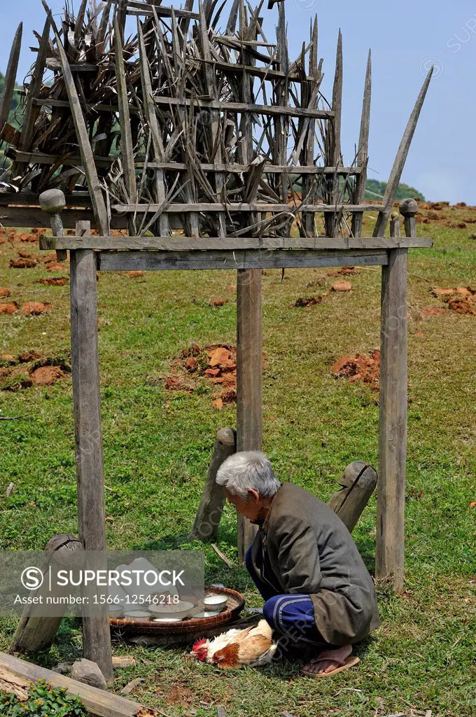 shaman preparing to sacrifice chicken in Akha tribe village in the mountains surrounding Muang La, Oudomxay Province in northwestern Laos, Southeast A...