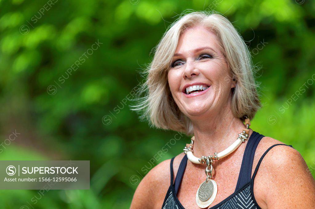 A happy 60 Year old blond woman and a 66 year old man smiling at the  camera, outdoors, Stock Photo, Picture And Rights Managed Image. Pic.  E94-3371079
