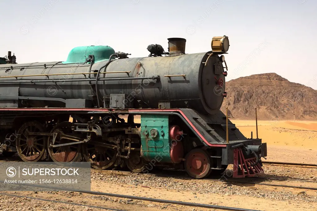 Preserved steam locomotive on the Hijaz Railway, near Wadi Rum, Jordan. An Old Turkish Steam Train Used In The Movie Lawrence Of Arabia Sits In The Sa...