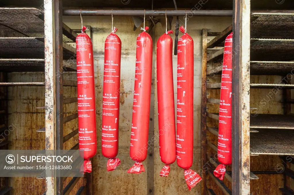 Tubes of baloney hanging from a pipe in smoker in Frostburg,MD.