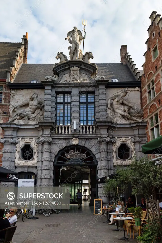 The Old Fish Market with the statue of the Roman god Neptune with trident above the entrance in Ghend, Belgium.
