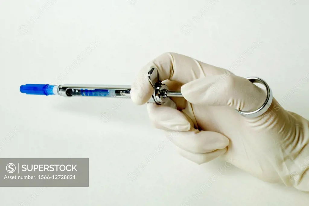 A novocaine carpule is inserted into a anesthetic syringe by a dentist. A carpule is a type of ampule or cartridge containing liquid medication. Note ...