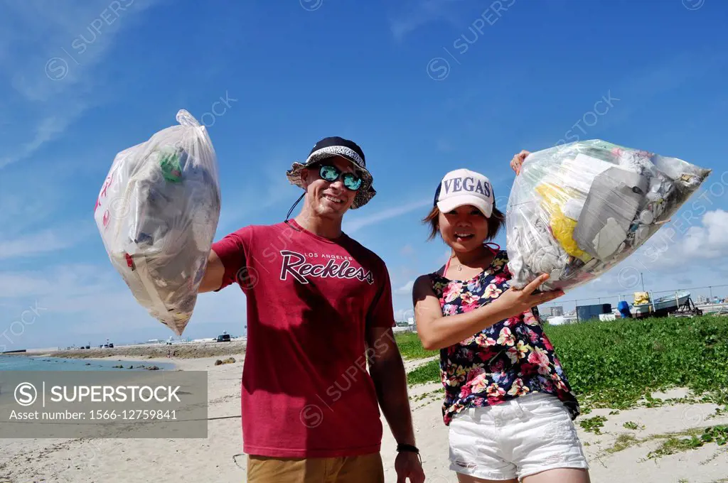 Senagajima, Okinawa, Japan: volunteers cleaning up the beach - SuperStock