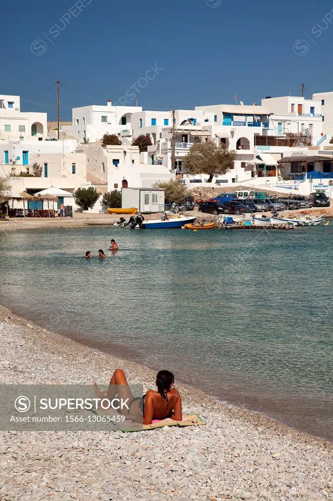 People sunbathing and swimming near the port, Folegandros, Cyclades Islands, Greek Islands, Greece, Europe.