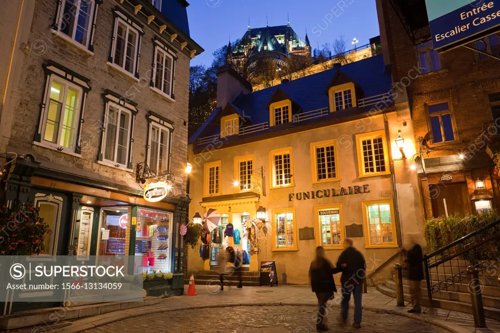 Old Town Quebec City, ""Vieux-Quebec"", Canada: Shops and entrance to cable car, ""Funiculaire"", to upper town and Chateau Frontenac, dusk.