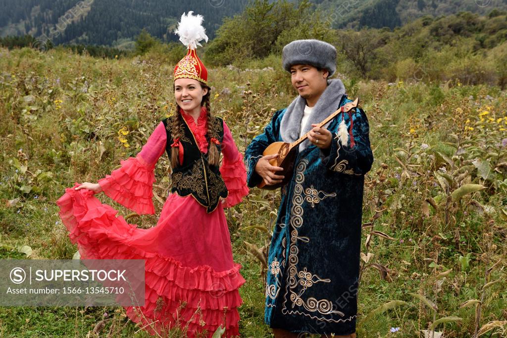 The specificities of Kazakh traditional women clothes are long and wide