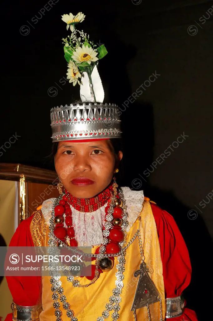 Tribal Girl in traditional Khasi dress called Jainsem giving the