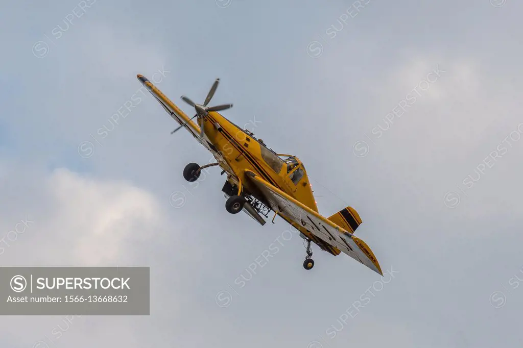 A crop-duster plane flies over a farm and coats crops with pesticides in Secretary, Maryland.