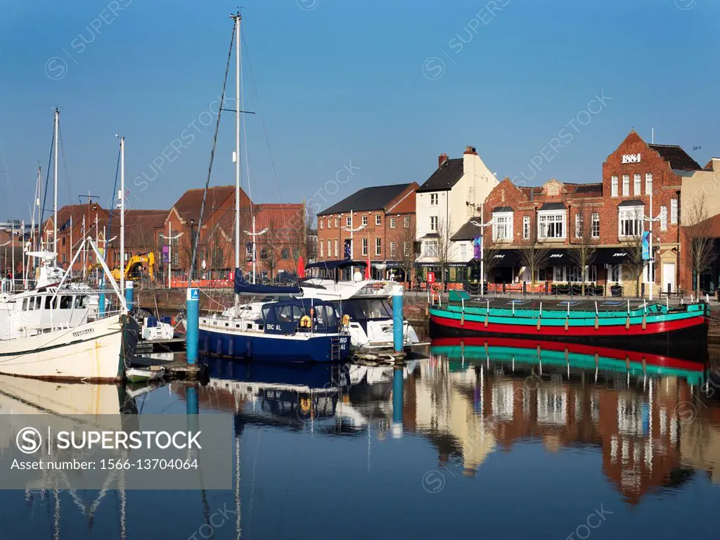 Boats and Buildings on Humber Dock Street reflected in Hull Marina Hull Yorkshire England.