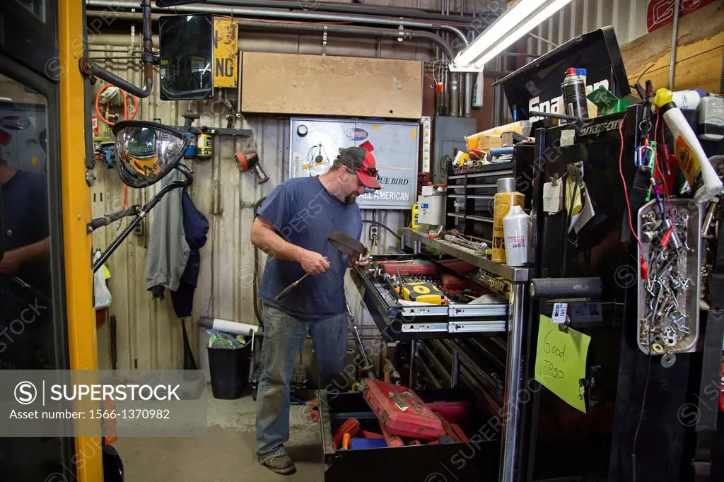 West Branch, Michigan - School bus mechanic in the bus garage at Surline Elementary and Middle Schools. School support staff are members of the United...